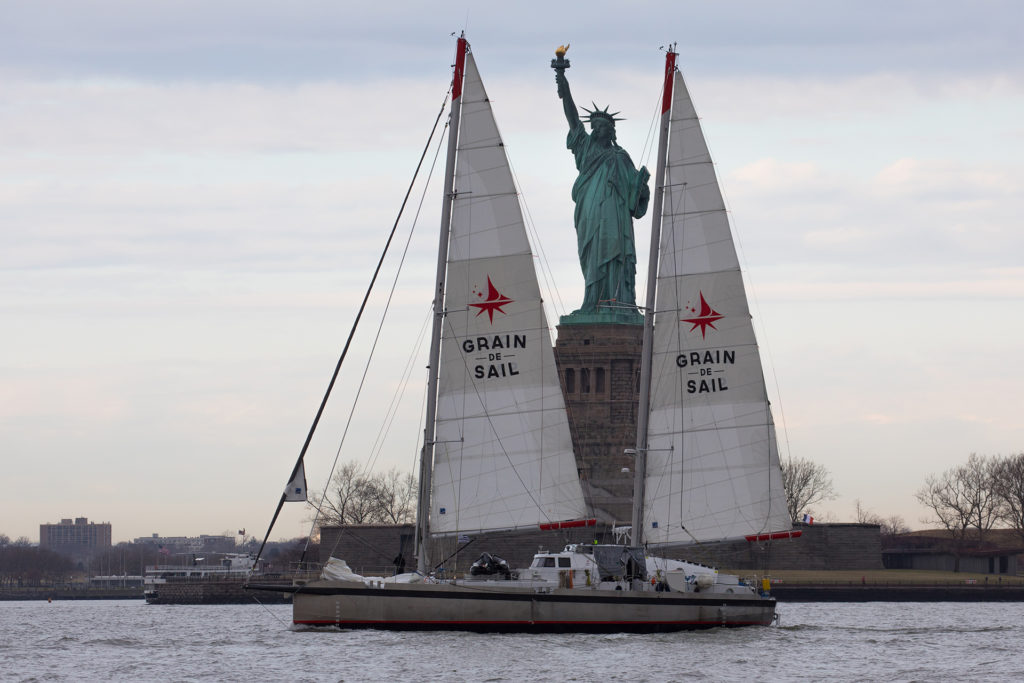 The Grain de Sail boat sailing past the Statue of Liberty